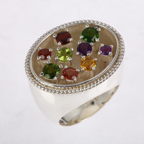 1388 - A large sterling silver gem set dress ring, gemstones include peridot amethyst citrine and garnet, s... 