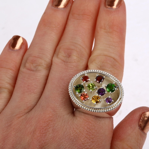 1388 - A large sterling silver gem set dress ring, gemstones include peridot amethyst citrine and garnet, s... 