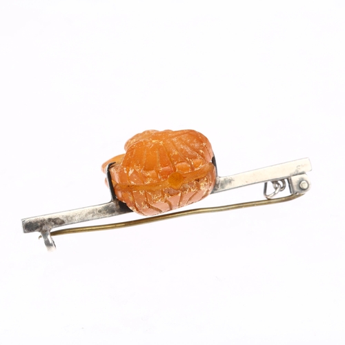 1390 - An early 20th century Archaeological  Revival double-sided amber Egyptian Pharaoh head bar brooch, a... 