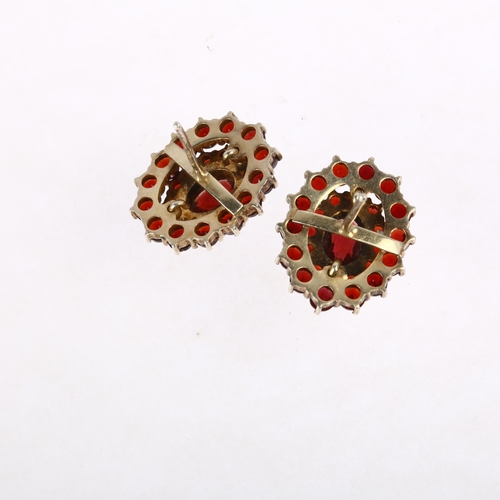 1398 - A pair of Bohemian garnet oval cluster earrings, unmarked silver-gilt settings with stud fittings, 1... 