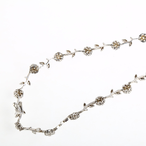 1403 - A modern sterling silver cubic zirconia flowerhead line necklace, 44cm, 29.8g