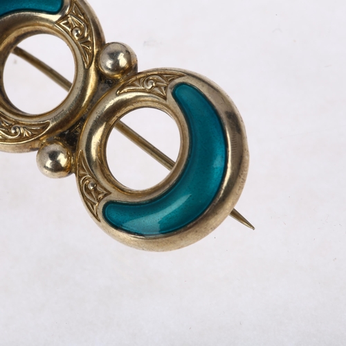 1452 - ALBERT SCHARNING - a Norwegian sterling silver-gilt teal enamel openwork brooch, 37mm, 5.7g