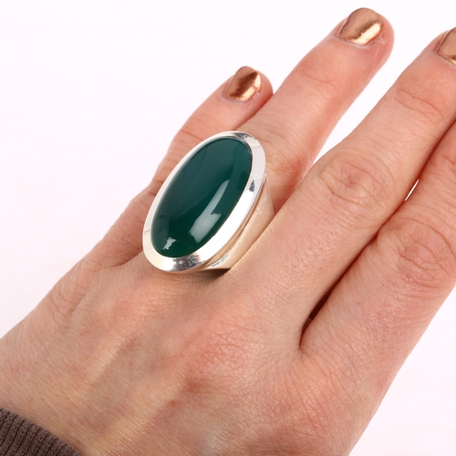 1463 - A large sterling silver green chalcedony dress ring, rub-over set with large oval cabochon chalcedon... 