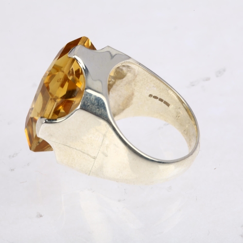 1483 - A large sterling silver citrine dress ring, setting height 23.2mm, size R, 17.4g