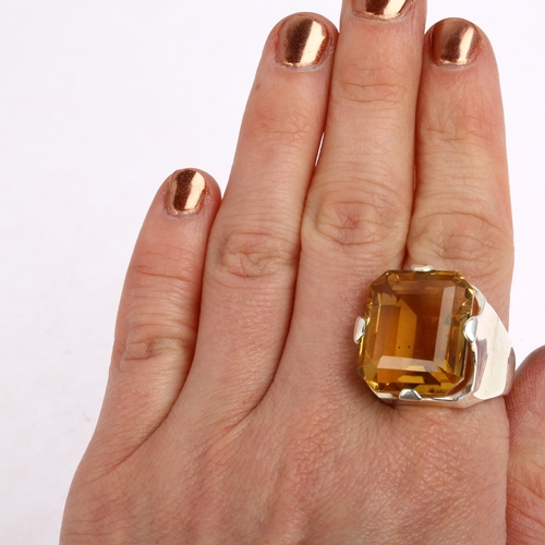 1483 - A large sterling silver citrine dress ring, setting height 23.2mm, size R, 17.4g