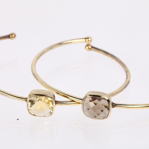 1489 - DINNY HALL - a pair of designer sterling silver-gilt gem set torque bangles, comprising smoky quartz... 