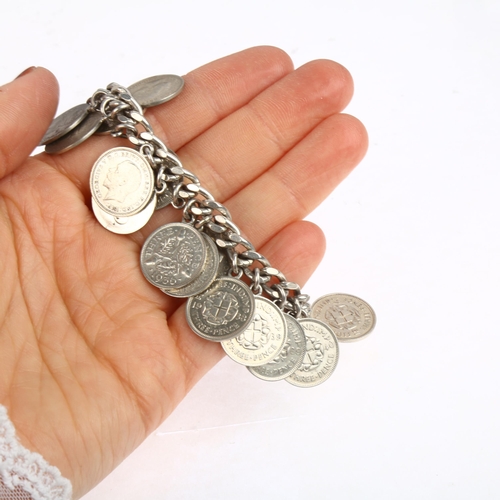 1514 - A sterling silver three pence coin charm bracelet, and a silver slave bangle, 18cm and 21cm, 71.2g t... 