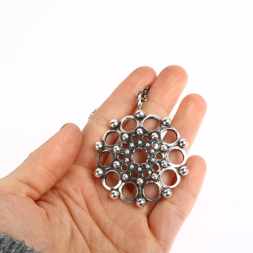 1538 - KALEVALA KORU - a Finnish modernist sterling silver openwork flowerhead pendant necklace, circa 1979... 