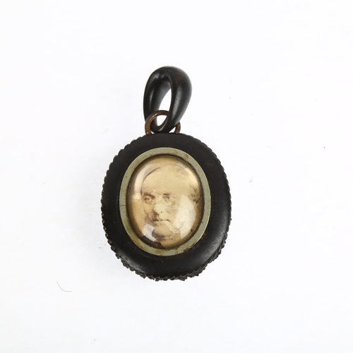 1550 - A 19th century carved jet mourning locket pendant, with monogram front and domed glass backing, 75.1... 