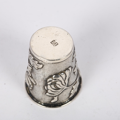 1627 - A Chinese export silver 'chrysanthemum' drinking tot, retailed by Wang Hing, relief embossed decorat... 