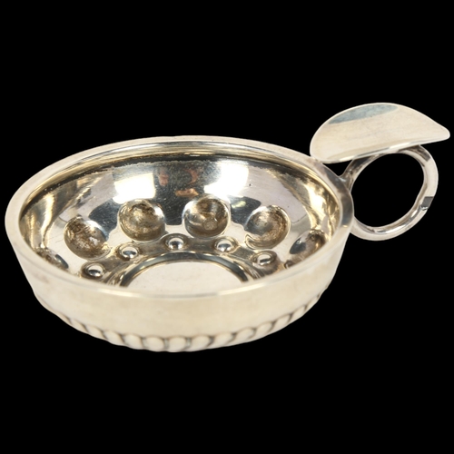 1655 - A small French silver wine taster, with relief embossed decoration, indistinct maker's mark, bowl di... 