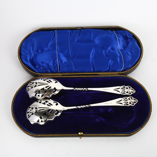 1669 - A pair of George V silver strawberry spoons, Martin Hall & Co, Sheffield 1910, pierced foliate decor... 