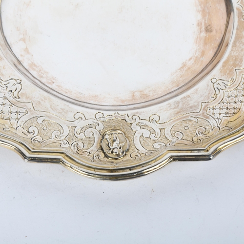 1686 - A 19th century German/Swiss parcel-gilt dinner plate, indistinct marks, scalloped circular form with... 