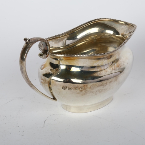 1695 - A George V silver cream jug, Barker Brothers & Sons Ltd, Birmingham 1931, oval bulbous form with gad... 