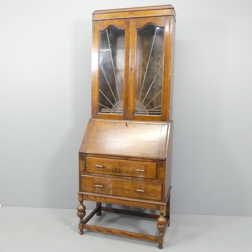 2127 - An Art Deco oak two-section bureau bookcase, with two leadlight glazed doors, a fall-front revealing... 