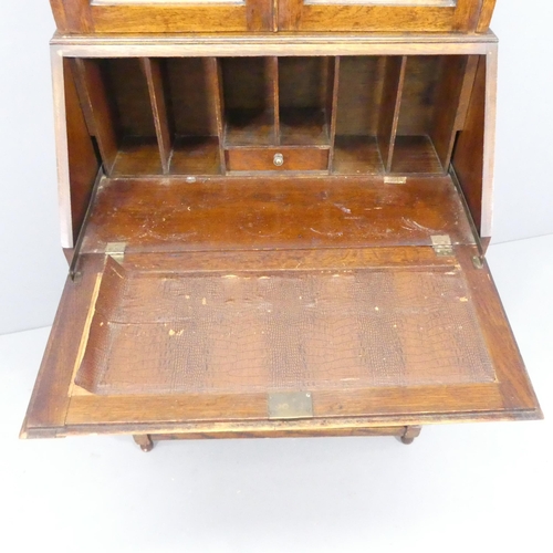 2127 - An Art Deco oak two-section bureau bookcase, with two leadlight glazed doors, a fall-front revealing... 