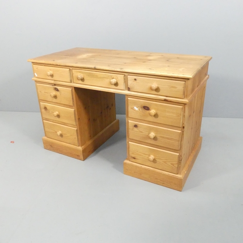 2131 - A modern pine pedestal writing desk. Overall 123x78x59cm, kneehole 37x62cm.