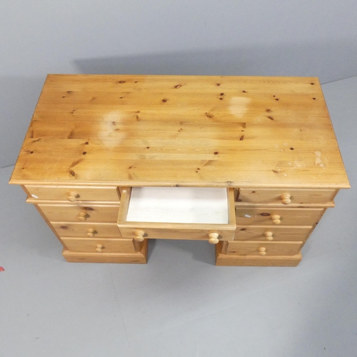 2131 - A modern pine pedestal writing desk. Overall 123x78x59cm, kneehole 37x62cm.