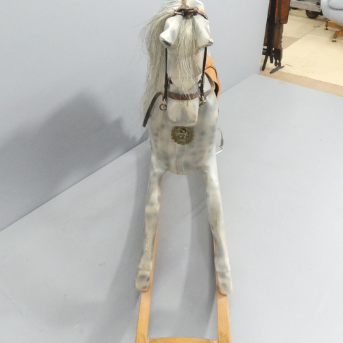 2137 - A painted wooden rocking horse, with leather tack and horsehair tail. 150x100x35cm.