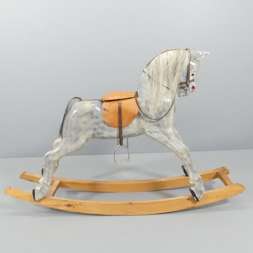 2137 - A painted wooden rocking horse, with leather tack and horsehair tail. 150x100x35cm.