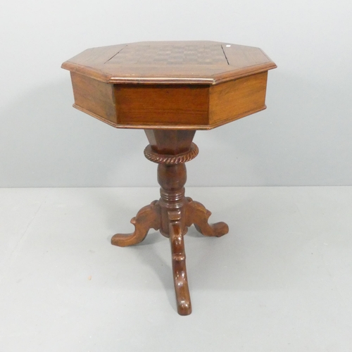 2152 - A modern mahogany octagonal games top occasional table, with lifting inset chessboard and tripod bas... 