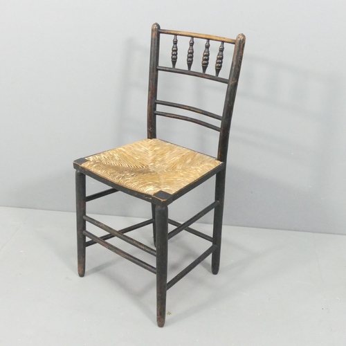 2155 - A Morris & Co Arts and Crafts Sussex chair, the ebonised spindle-back frame with rush seat.