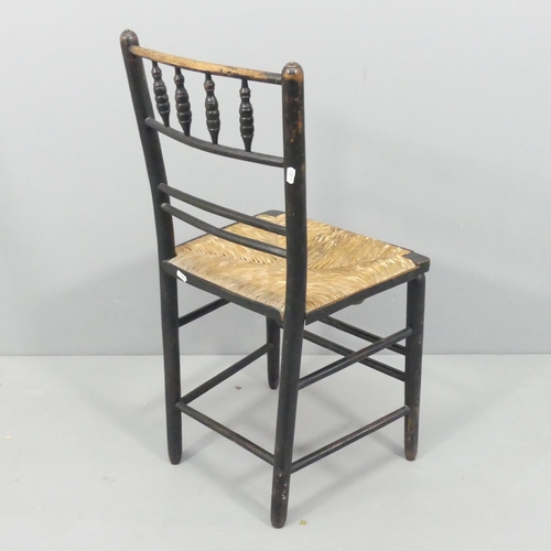 2155 - A Morris & Co Arts and Crafts Sussex chair, the ebonised spindle-back frame with rush seat.