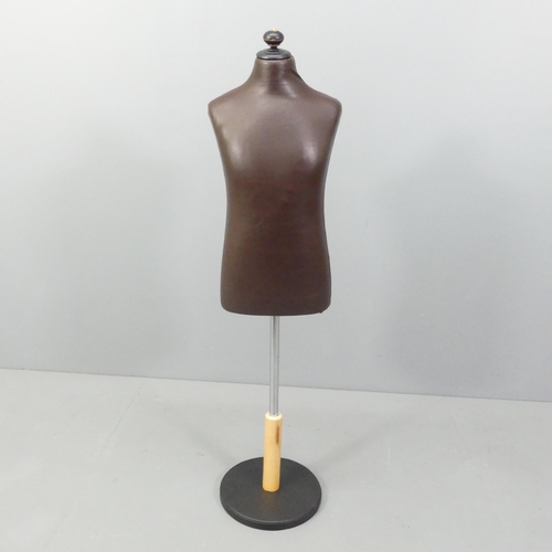 2166 - A modern leather covered mannequin on stand, of small male form. Height overall 130cm.