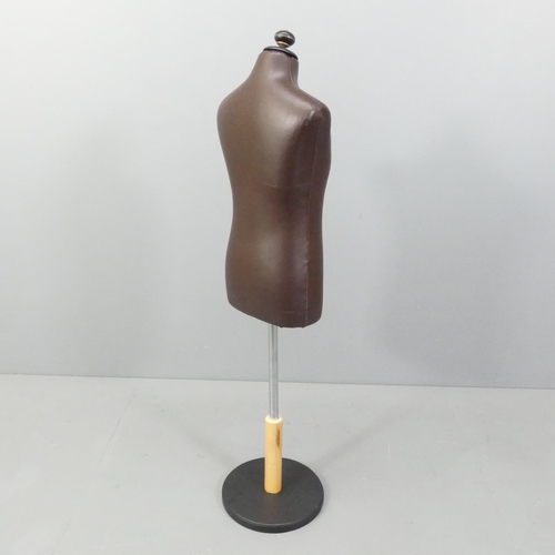 2166 - A modern leather covered mannequin on stand, of small male form. Height overall 130cm.