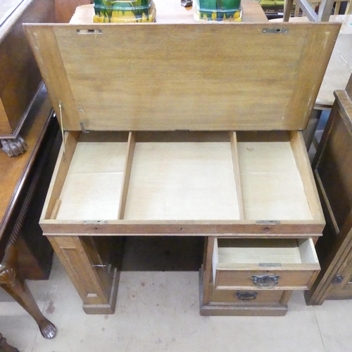 2189 - An early 20th century oak pedestal writing desk, with raised back, lifting lid, three drawers and cu... 