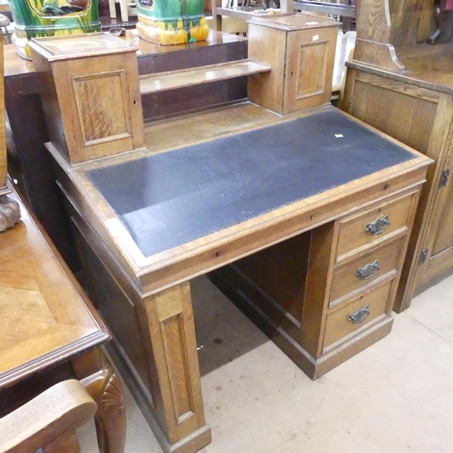 2189 - An early 20th century oak pedestal writing desk, with raised back, lifting lid, three drawers and cu... 