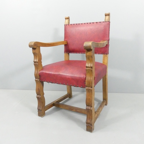 2194 - A 19th century Spanish style oak and leather upholstered open arm chair.