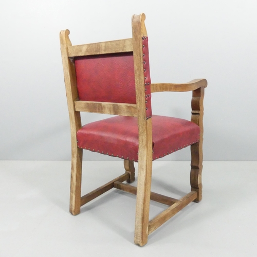 2194 - A 19th century Spanish style oak and leather upholstered open arm chair.