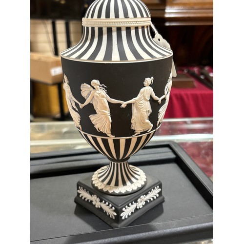 68 - Wedgwood black and white Jasper urn and cover, decorated with dancing maidens, height 25cm