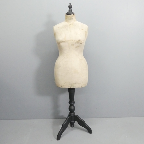 2048 - A Stockman's dressmaker's mannequin on ebonised tripod stand. Height 161cm.