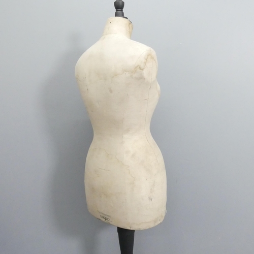 2048 - A Stockman's dressmaker's mannequin on ebonised tripod stand. Height 161cm.