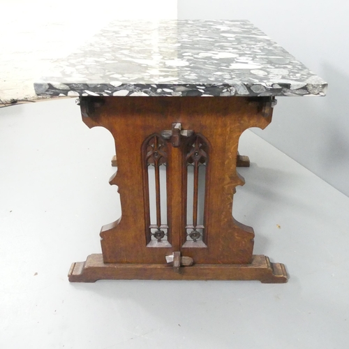 2052 - An early 20th century centre table, with polished Marinace granite top on gothic oak trestle base. 1... 