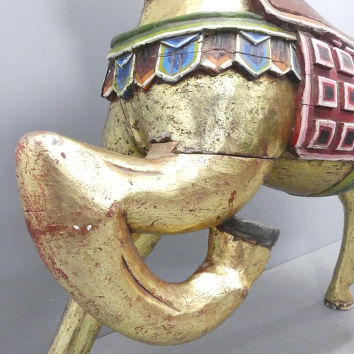 2057 - An Indonesian hand painted and gilded wooden horse. 137x132x44cm.