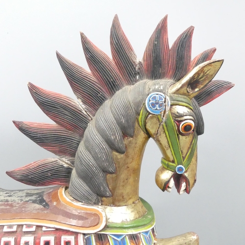 2057 - An Indonesian hand painted and gilded wooden horse. 137x132x44cm.