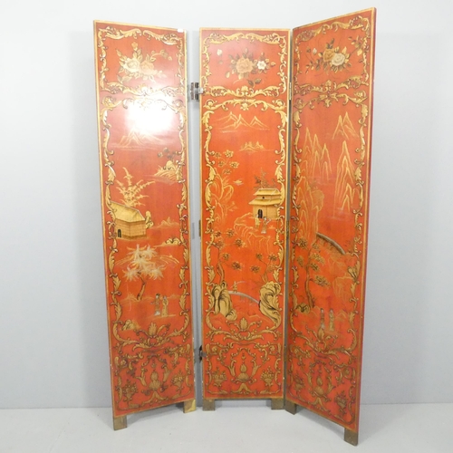 2063 - A Japanese red lacquered three-fold room divider screen, with gilded and painted decoration. Each pa... 