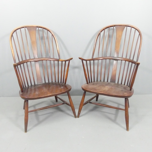 2072 - ERCOL - a pair of mid-century Chairmaker's comb-back elbow chairs. With maker's labels.