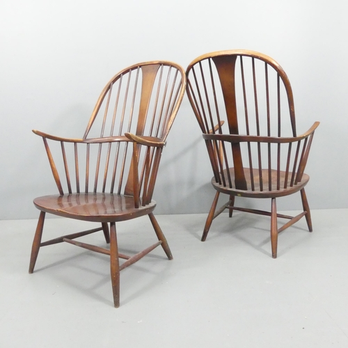 2072 - ERCOL - a pair of mid-century Chairmaker's comb-back elbow chairs. With maker's labels.