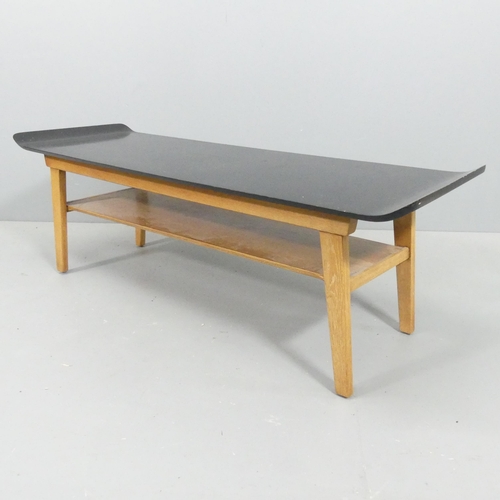 2074 - A mid-century Scandinavian design two-tier coffee table, with ebonised bent-ply top on teak base and... 