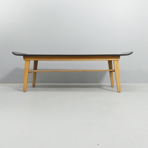 2074 - A mid-century Scandinavian design two-tier coffee table, with ebonised bent-ply top on teak base and... 