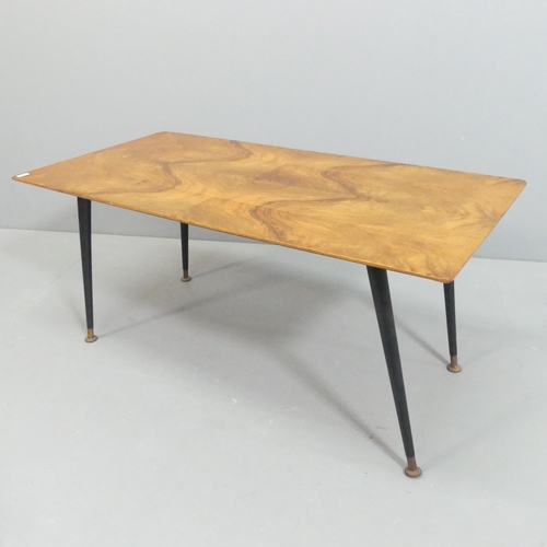 2083 - A mid-century walnut veneered plywood coffee table, raised on ebonised dansette legs. 90x40x45cm.