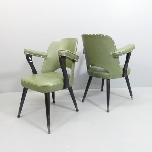 2087 - A pair of mid-century style faux-leather upholstered arm chairs on ebonised frame.