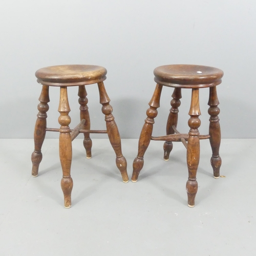 2126 - A pair of oak stools, raised on turned legs with cross stretcher. Seat dimensions 29x52cm.