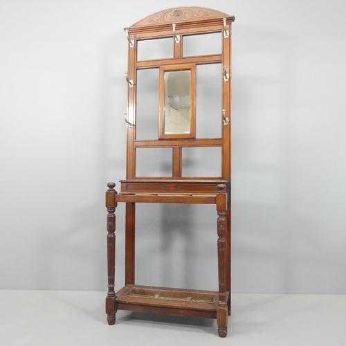 2130 - An early 20th century oak hallstand, with mirrored back, lidded compartment and original drip trays.... 