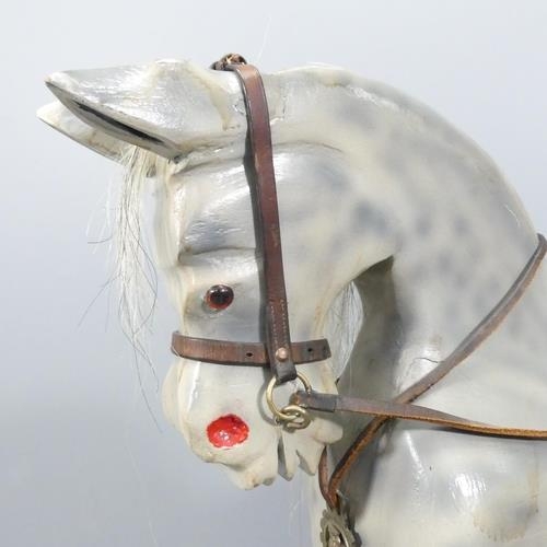 2137 - A painted wooden rocking horse, with leather tack and horsehair tail. 150x100x35cm.