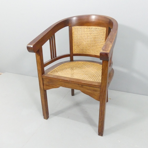 2159 - A stained teak Art Deco style bow-arm desk chair, with double cane panelled back and cane seat, with... 